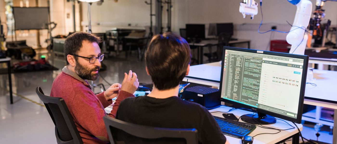 Dimitrios working with a student in the UCL robotics lab